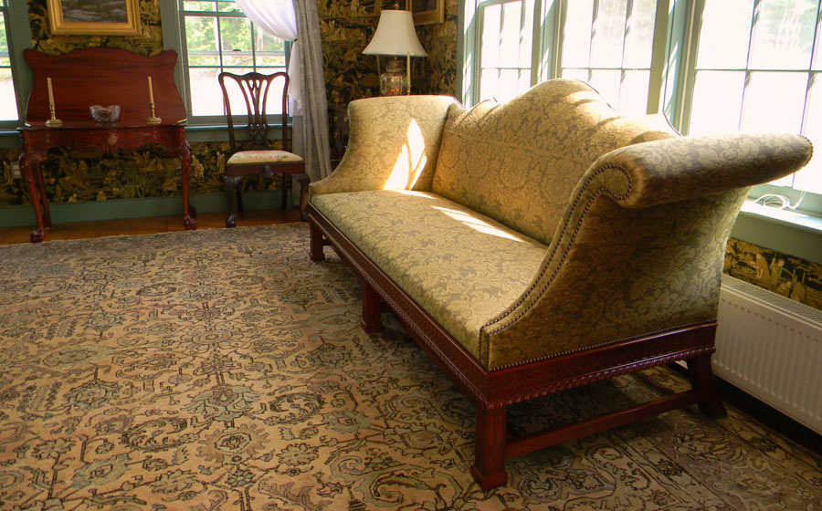 Cliveden sofa, mahogany, originally built by Thomas Affleck around 1765. It features the unique carving pattern on the front and side rails called gadrooning.