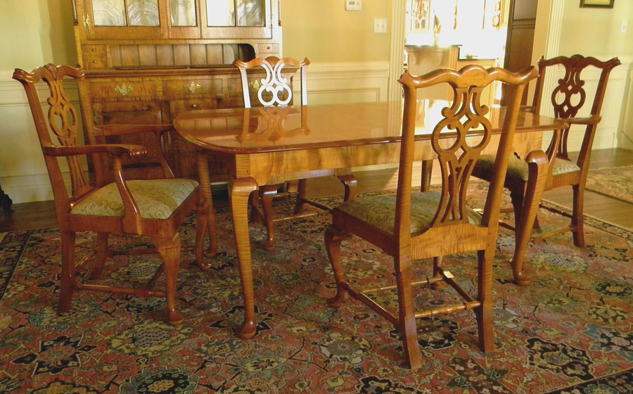 Chippendale Style Table and Chairs, curly maple. The chairs are built in the Massachusetts Chippendale style with the unique owl pattern in the splat. The legs of the table are chippendale but the design of the table is built for today's needs, expanding on slides to accept 2 leaves.