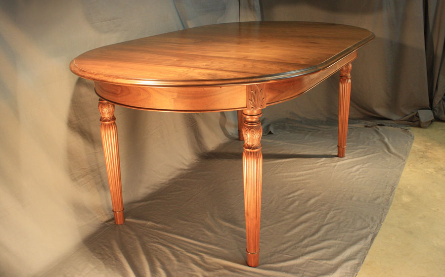 Custom Sheraton Style Dining Table, walnut.  This custom piece features sheraton style reeded legs, beaded curtain and hand built slides to accept two extension leaves.